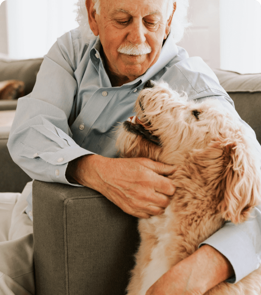 goldendoodle breeder with dog in hand