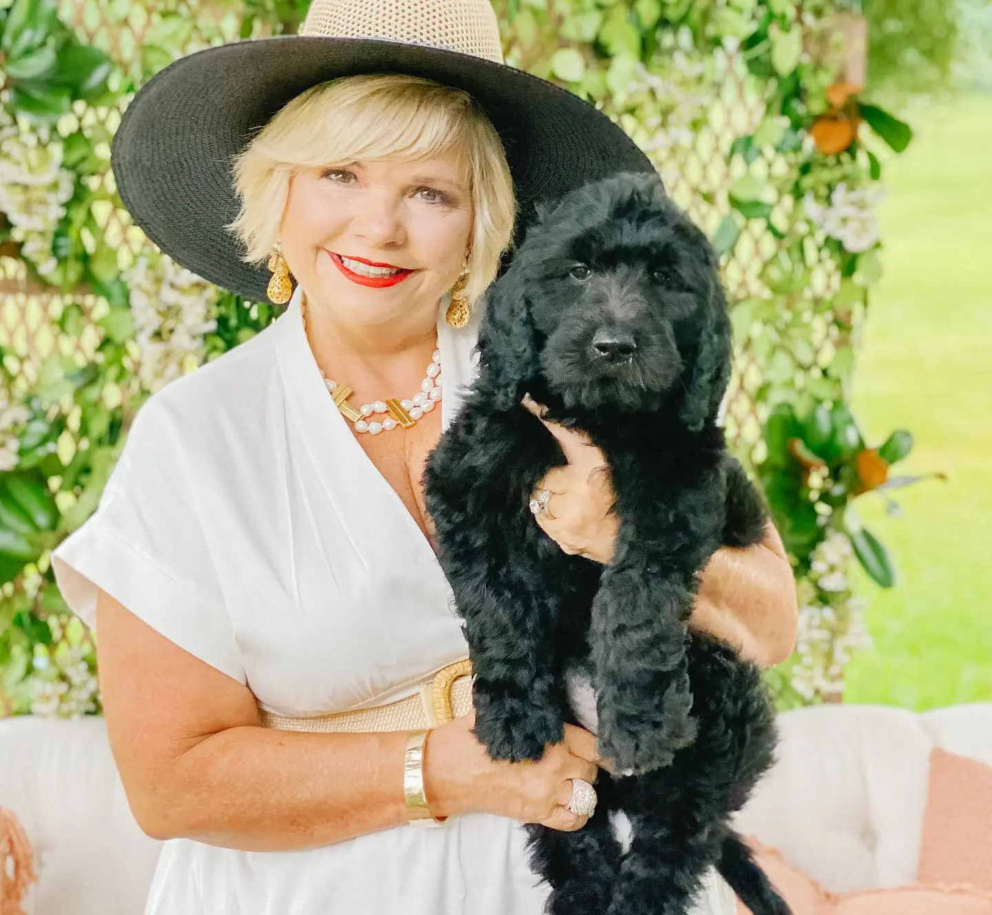 Sherri Smeraglia, owner of Smeraglia teddy bear golden doodles, holding one of her black, cute golden doodle puppies.