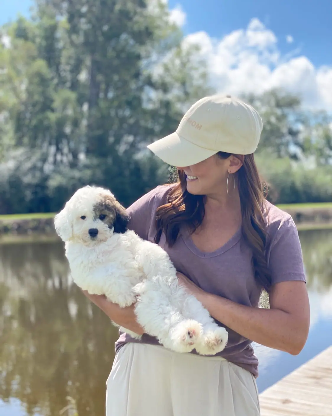 Taylor holding a wookie parti golden doodle. This wookie parti golden doodle is so adorable, it's hard to believe it's real!