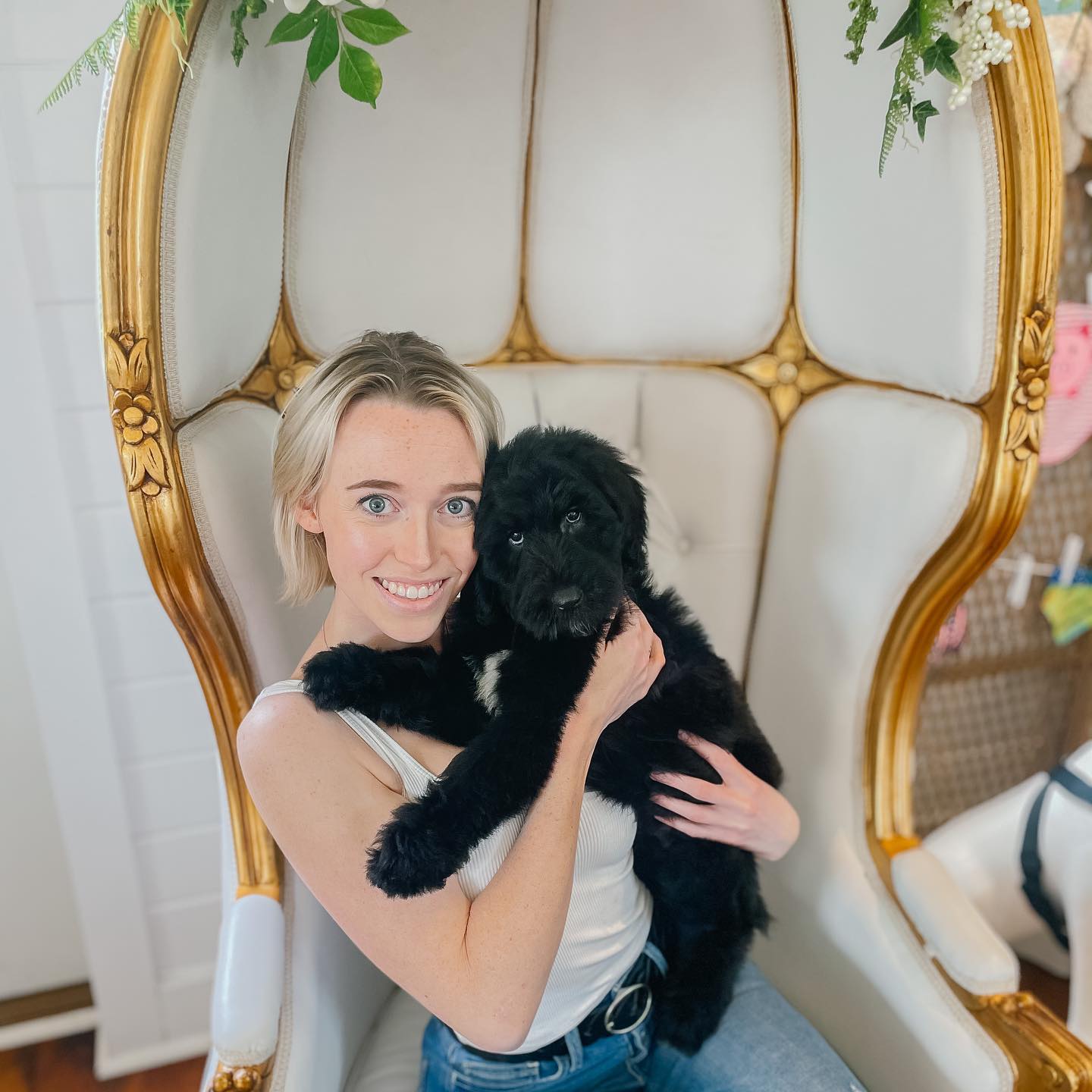 A Smeraglia client holding her new black golden doodle. She's so excited to have this friendly, allergy-friendly family member!