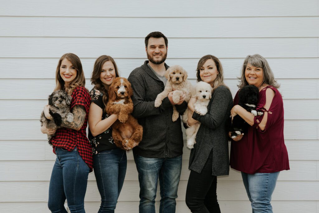 Members of our team, each holding a puppy
